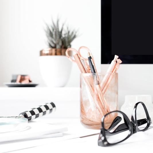 SEO Clarity Report built to give you clarity, not overwhelm. Business setup with computer monitor, glasses, and stationery items showing.